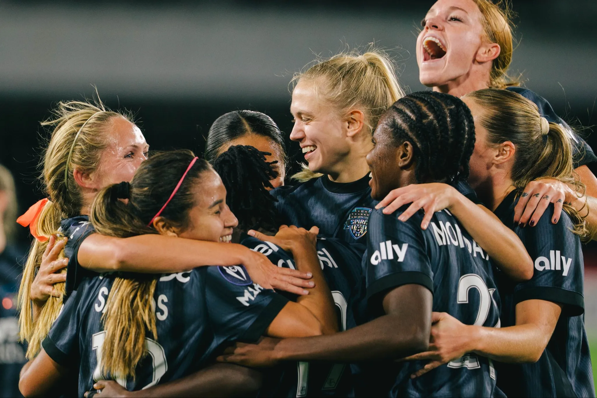 Gift Monday and teammates celebrating Washington Spirit to 4–0 victory over Monterrey